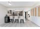 Eat-in kitchen offering bar seating, modern appliances, and ample storage space at 25188 Marion Ave # E409, Punta Gorda, FL 33950