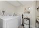 Bright laundry room with large capacity washer and dryer and storage at 25188 Marion Ave # E409, Punta Gorda, FL 33950
