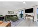 Cozy living room with a plush sofa, entertainment center, and balcony access at 25188 Marion Ave # E409, Punta Gorda, FL 33950