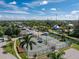 Aerial view of community tennis courts with surrounding green spaces, boat storage, and residential area at 25188 Marion Ave # E409, Punta Gorda, FL 33950