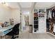 Well-organized walk-in closet and home office area with custom shelving and bright lighting at 25188 Marion Ave # E409, Punta Gorda, FL 33950