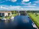 Waterfront condos with boat docks, blue water, and tropical landscaping on a sunny day with blue skies at 25188 Marion Ave # E409, Punta Gorda, FL 33950