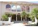 Elegant Yacht Club building with arched windows, landscaping, offering a luxurious ambiance at 25188 Marion Ave # F106, Punta Gorda, FL 33950