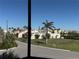 Scenic view of the neighborhood and palm trees through a screened-in porch at 25188 Marion Ave # F106, Punta Gorda, FL 33950