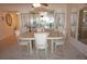 Elegant dining room featuring marble table with white chairs and a mirrored display cabinet at 25188 Marion Ave # F106, Punta Gorda, FL 33950