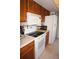 Kitchen featuring an electric stove, microwave, and a white refrigerator with light-colored cabinets at 25188 Marion Ave # F106, Punta Gorda, FL 33950