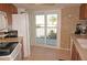 Cozy kitchen with tiled walls, stainless steel appliances, and sliding door to a balcony at 25188 Marion Ave # F106, Punta Gorda, FL 33950