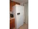 Bright kitchen featuring a refrigerator with water dispenser and access to the lanai at 25188 Marion Ave # F106, Punta Gorda, FL 33950