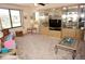 Bright living room featuring neutral carpeting, built-in cabinetry and comfortable seating at 25188 Marion Ave # F106, Punta Gorda, FL 33950