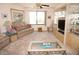 Bright living room featuring neutral carpeting and comfortable seating at 25188 Marion Ave # F106, Punta Gorda, FL 33950