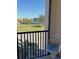Balcony seating offers scenic views of water and lush landscaping beyond at 25188 Marion Ave # F106, Punta Gorda, FL 33950