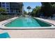 Outdoor swimming pool with clear water, surrounded by a fenced area and lounge chairs for relaxation at 25188 Marion Ave # F106, Punta Gorda, FL 33950