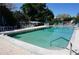 A clean outdoor pool surrounded by lounge chairs and umbrellas, perfect for a refreshing swim at 25188 Marion Ave # F106, Punta Gorda, FL 33950