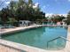 Inviting community pool surrounded by lounge chairs and well-maintained landscaping at 25188 Marion Ave # F106, Punta Gorda, FL 33950