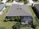 Aerial view showcases a home's well-maintained backyard and screened lanai, perfect for relaxing at 25325 E Lenox Cir, Punta Gorda, FL 33950
