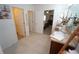 Bathroom with tiled floors, single sink vanity, and doorways to the main bedroom and hallway at 25325 E Lenox Cir, Punta Gorda, FL 33950