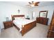 Well-lit bedroom with ceiling fan, and traditional furnishings including dresser with mirror at 25325 E Lenox Cir, Punta Gorda, FL 33950