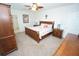 Comfortable bedroom with a ceiling fan and ensuite bathroom with traditional furnishings at 25325 E Lenox Cir, Punta Gorda, FL 33950