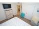 Cozy bedroom featuring dresser with a TV, a nightstand, and a connecting bathroom at 25325 E Lenox Cir, Punta Gorda, FL 33950