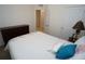 Cozy bedroom featuring light walls, carpet flooring, and a beach-themed decor at 25325 E Lenox Cir, Punta Gorda, FL 33950