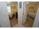 View between two bedrooms with carpet flooring, light walls, and coastal decor at 25325 E Lenox Cir, Punta Gorda, FL 33950