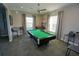 Well lit billiards room features a full size pool table with comfortable seating, barstool seating, and large picture windows at 25325 E Lenox Cir, Punta Gorda, FL 33950
