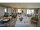 Open concept community clubhouse gathering room featuring a lounge area with plush seating and a dining area with tables and chairs at 25325 E Lenox Cir, Punta Gorda, FL 33950