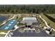 Community clubhouse featuring tennis and pickleball courts, a pool, and meticulous landscaping at 25325 E Lenox Cir, Punta Gorda, FL 33950