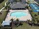 Relaxing community pool with palm trees, lounge chairs, and meticulous landscaping at 25325 E Lenox Cir, Punta Gorda, FL 33950