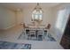 Bright dining area with elegant lighting, seating for six, and access to other rooms at 25325 E Lenox Cir, Punta Gorda, FL 33950