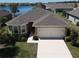 Inviting single-Gathering home with a two-car garage, manicured landscaping, and beautiful lakeside views at 25325 E Lenox Cir, Punta Gorda, FL 33950