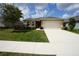 Lovely home with a well-maintained lawn, two car garage, and charming curb appeal at 25325 E Lenox Cir, Punta Gorda, FL 33950