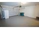Clean garage with epoxy flooring, an overhead door, and space for multiple cars and storage at 25325 E Lenox Cir, Punta Gorda, FL 33950