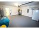 Spacious garage with painted floors, equipped with storage shelves, water heater, and extra refrigerator at 25325 E Lenox Cir, Punta Gorda, FL 33950