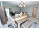Open-concept living space with modern furniture, seamlessly connecting the dining and living areas at 25325 E Lenox Cir, Punta Gorda, FL 33950