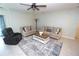 Cozy living room featuring comfortable seating, a decorative rug, and a serene ambiance at 25325 E Lenox Cir, Punta Gorda, FL 33950