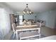 Open-concept living and dining area with coastal decor and sliding door access to patio at 25325 E Lenox Cir, Punta Gorda, FL 33950