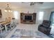 Inviting living room features an entertainment center, dining table, and comfortable armchair, creating a relaxing space at 25325 E Lenox Cir, Punta Gorda, FL 33950