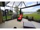 Scenic view from the screened patio overlooking a lake, creating a peaceful outdoor experience at 25325 E Lenox Cir, Punta Gorda, FL 33950