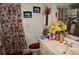 Bathroom featuring a floral shower curtain, framed art, and ample counter space at 25472 Tevesine Ct, Punta Gorda, FL 33983