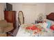 Cozy bedroom featuring a floral patterned quilt, wood furniture, and ample closet space at 25472 Tevesine Ct, Punta Gorda, FL 33983