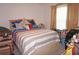 Bright bedroom with striped bedding, throw pillows, and personal items at 25472 Tevesine Ct, Punta Gorda, FL 33983