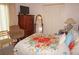 Cozy bedroom features a floral patterned quilt, wood furniture, and ample closet space at 25472 Tevesine Ct, Punta Gorda, FL 33983