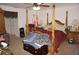 Spacious bedroom with a large four-post bed and a ceiling fan at 25472 Tevesine Ct, Punta Gorda, FL 33983