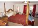 Bedroom with a large four-post bed and a ceiling fan at 25472 Tevesine Ct, Punta Gorda, FL 33983