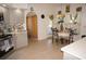 Bright kitchen with updated gray cabinetry, stainless appliances, and tile flooring leading to an outdoor dining area with pool access at 25472 Tevesine Ct, Punta Gorda, FL 33983