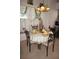 Dining area with decorative table setting, wrought iron chairs, and window treatments, adjacent to the kitchen at 25472 Tevesine Ct, Punta Gorda, FL 33983