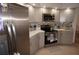 Bright kitchen featuring gray cabinetry, stainless steel appliances, and a spacious countertop for cooking and meal preparation at 25472 Tevesine Ct, Punta Gorda, FL 33983