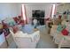 Spacious living room with couches, television, and large window at 25472 Tevesine Ct, Punta Gorda, FL 33983