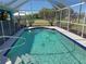 Inviting screened-in pool featuring clear blue water, a calming fountain, and convenient access steps at 25472 Tevesine Ct, Punta Gorda, FL 33983